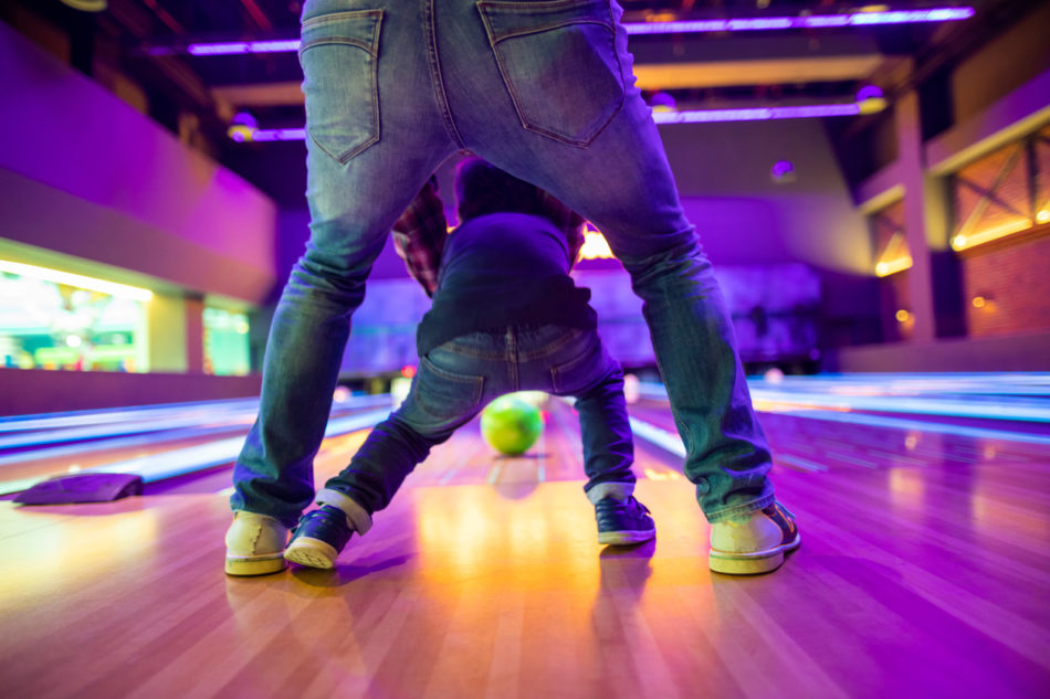 Father and son at bowling alley