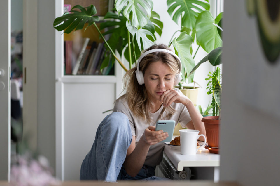 woman listening to podcast