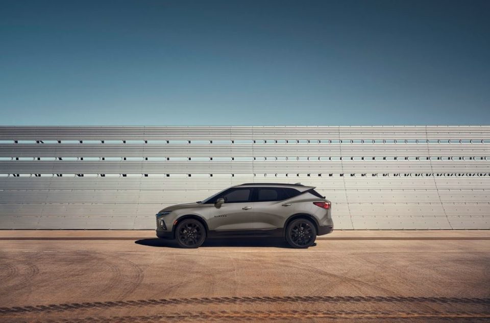 Chevy Blazer by fence along racetrack