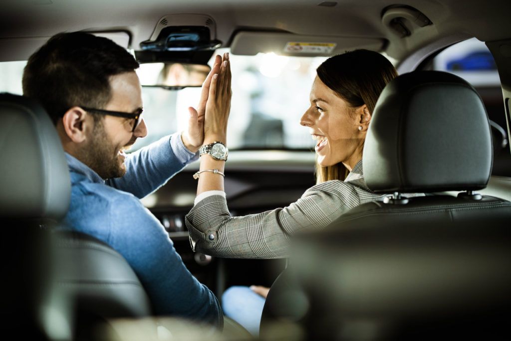 Happy couple excited about buying a car