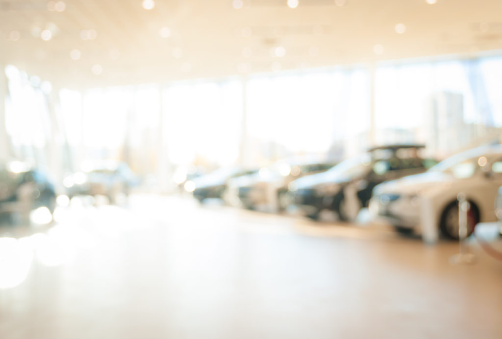 Abstract background of blurred new cars at a dealership