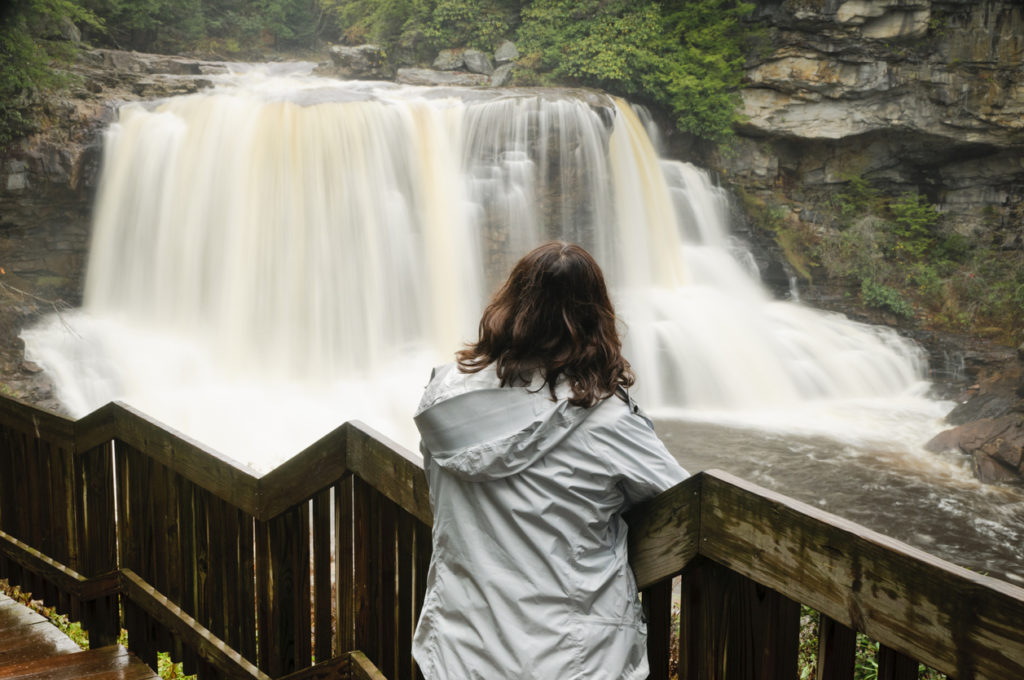 woman admiring waterfall.