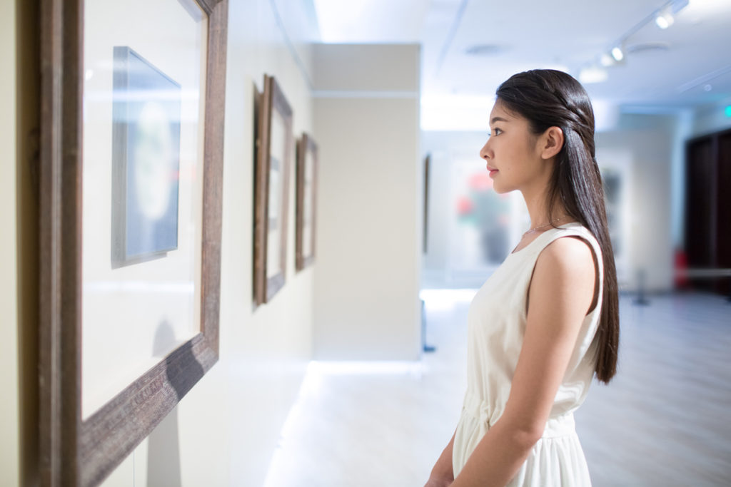 girl admiring art in a museum