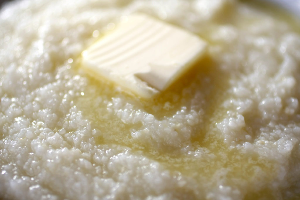 close up of butter melting on grits